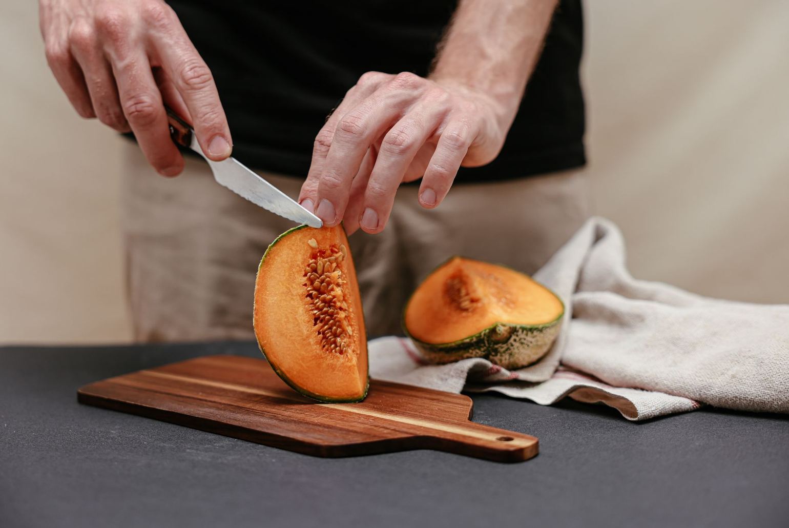fleshing knife resting on a hide over a wooden beam
